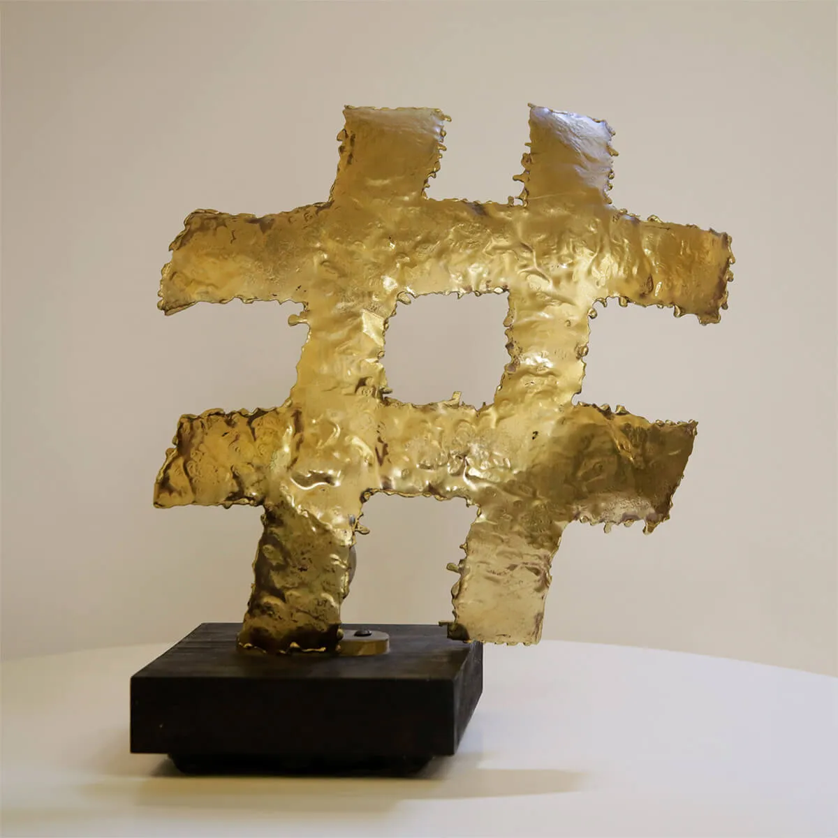 Hashtag - Backlit brass sculpture on wooden base