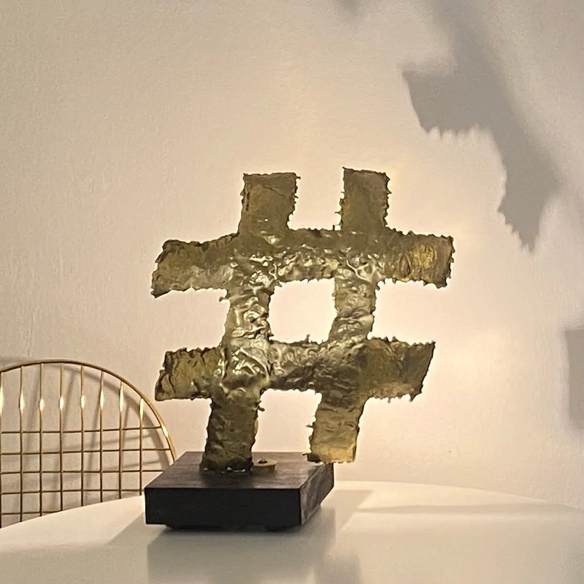 Hashtag - Backlit brass sculpture on wooden base